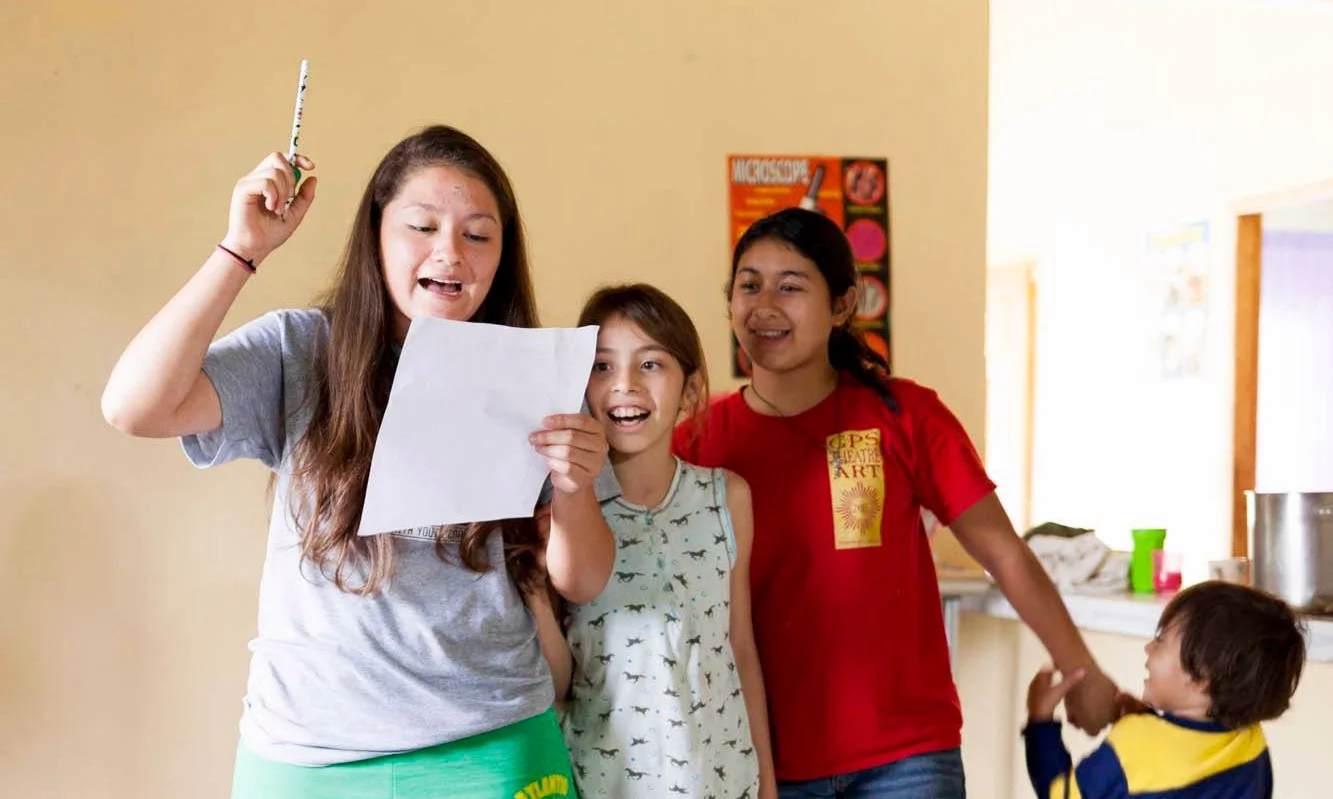 Mariela, Michelle, Ana, and Jaxon performing their own song about the Learning Center 