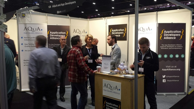 The Apps Alliance team chats with visitors to the booth shared with AQuA.
