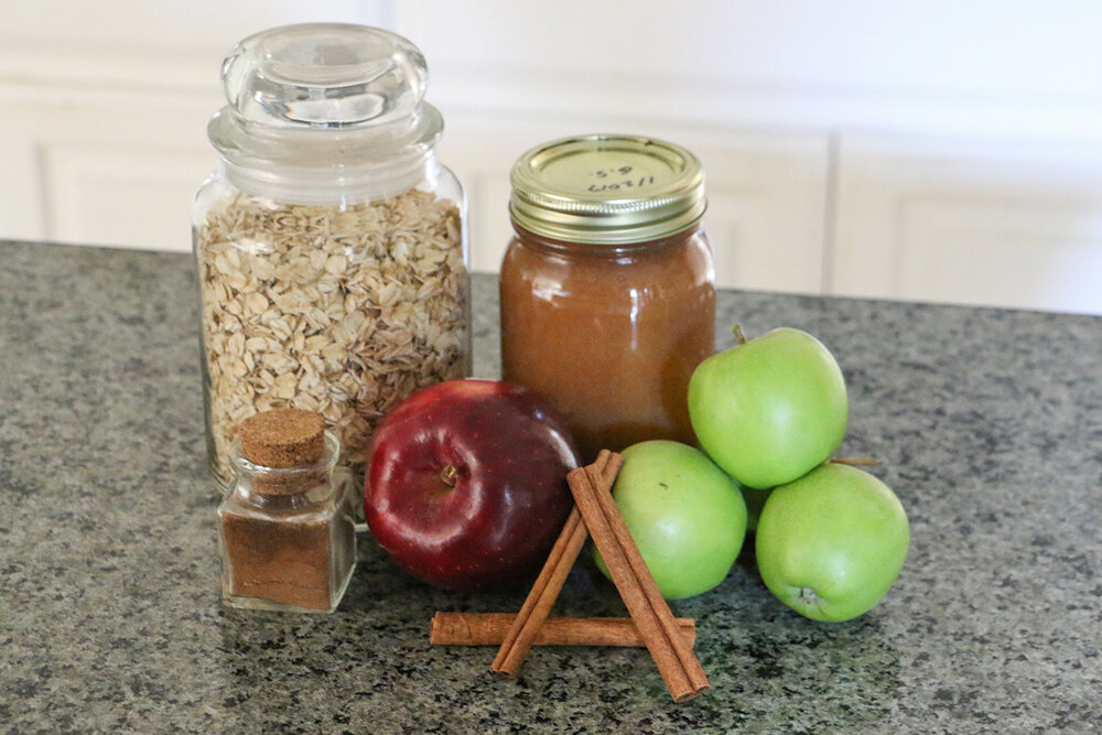 Healthy apple cookie ingredients, homemade applesauce, cinnamon sticks, oats