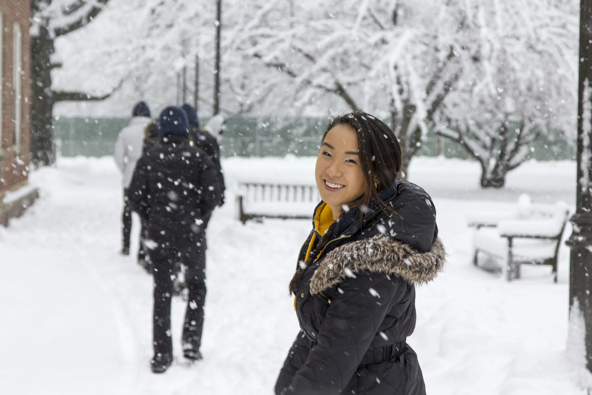 snow falls over female model