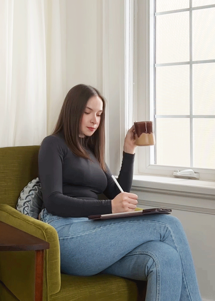 Photo of me sipping a coffee while sketching on my iPad.