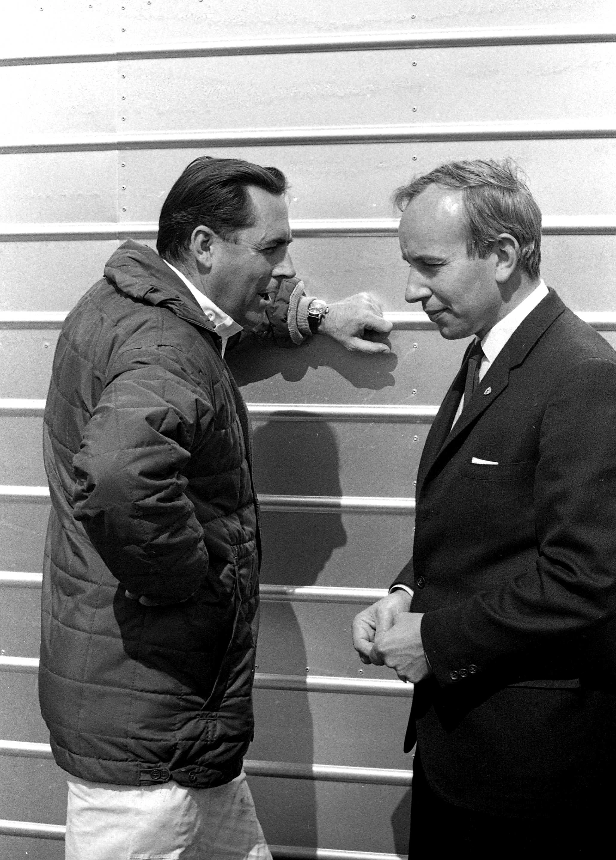 He did speak sometimes. Jack Brabham (left) in deep conversation with John Surtees.