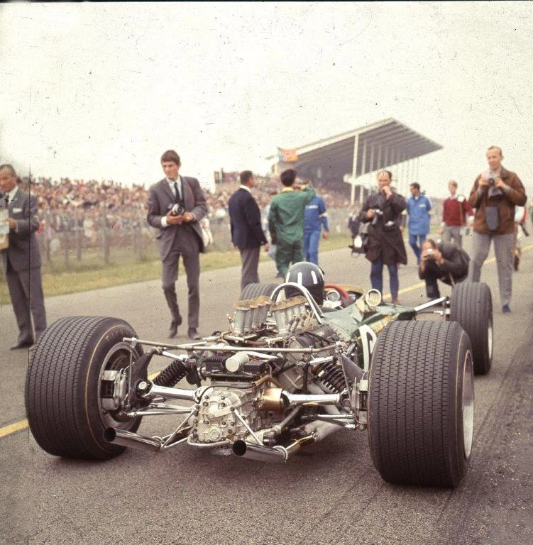 Graham Hill on the main straight at Zandvoort. He went on to win the 1968 World Championship in a 49B. This is the pre-wing era of Formula 1. Chapman put aerofoils on sticks on the 1969 car, and I watched Hill and Jochen Rindt crashing disastrously at the Spanish Grand Prix. Photo © Eric Dymock