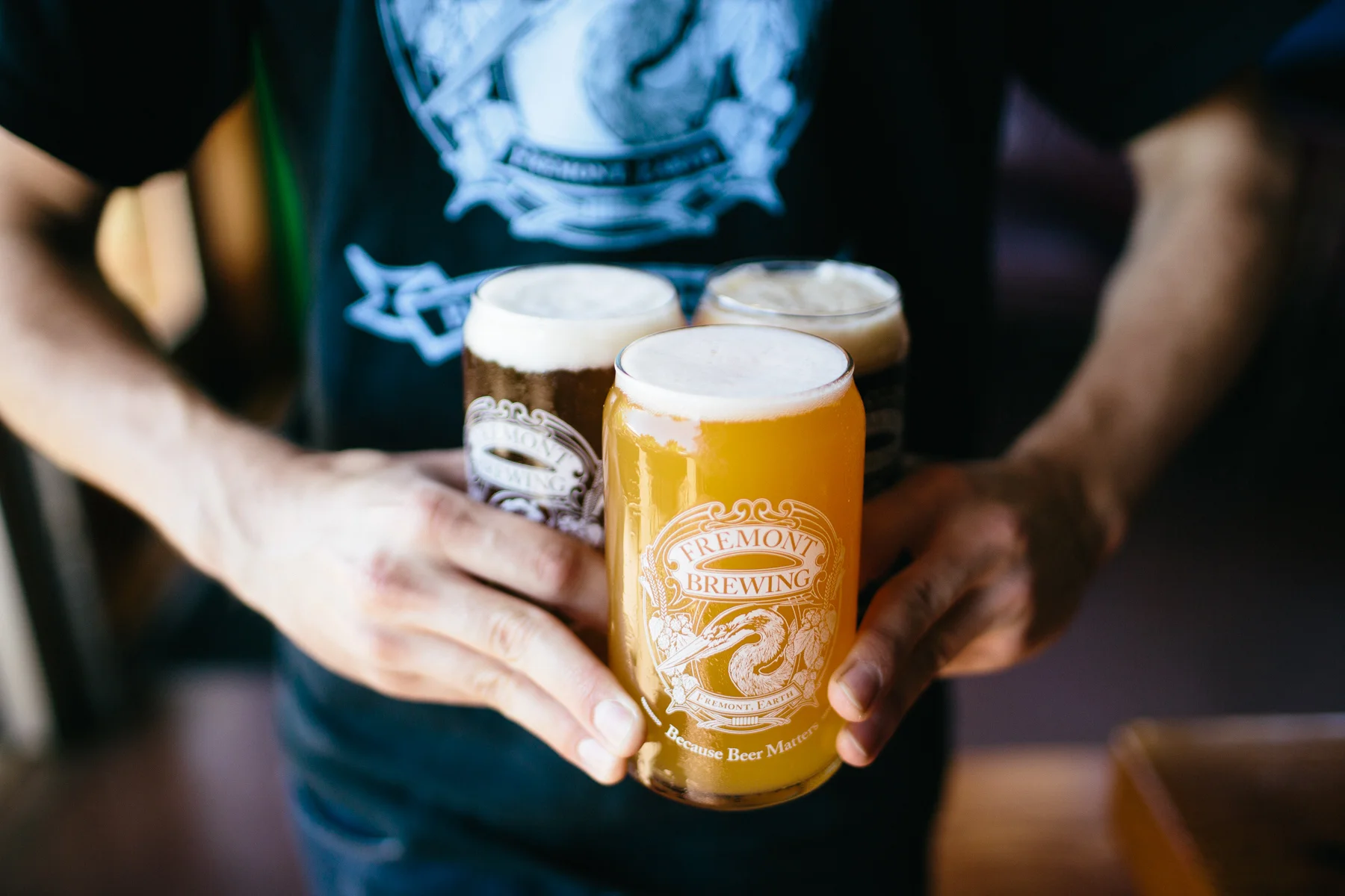 Fremont server holding three pints of beer