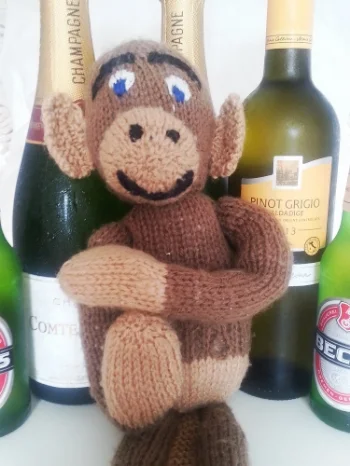 This is a toy monkey making a 'T' for 'Time Out'. Just in case it's not clear.