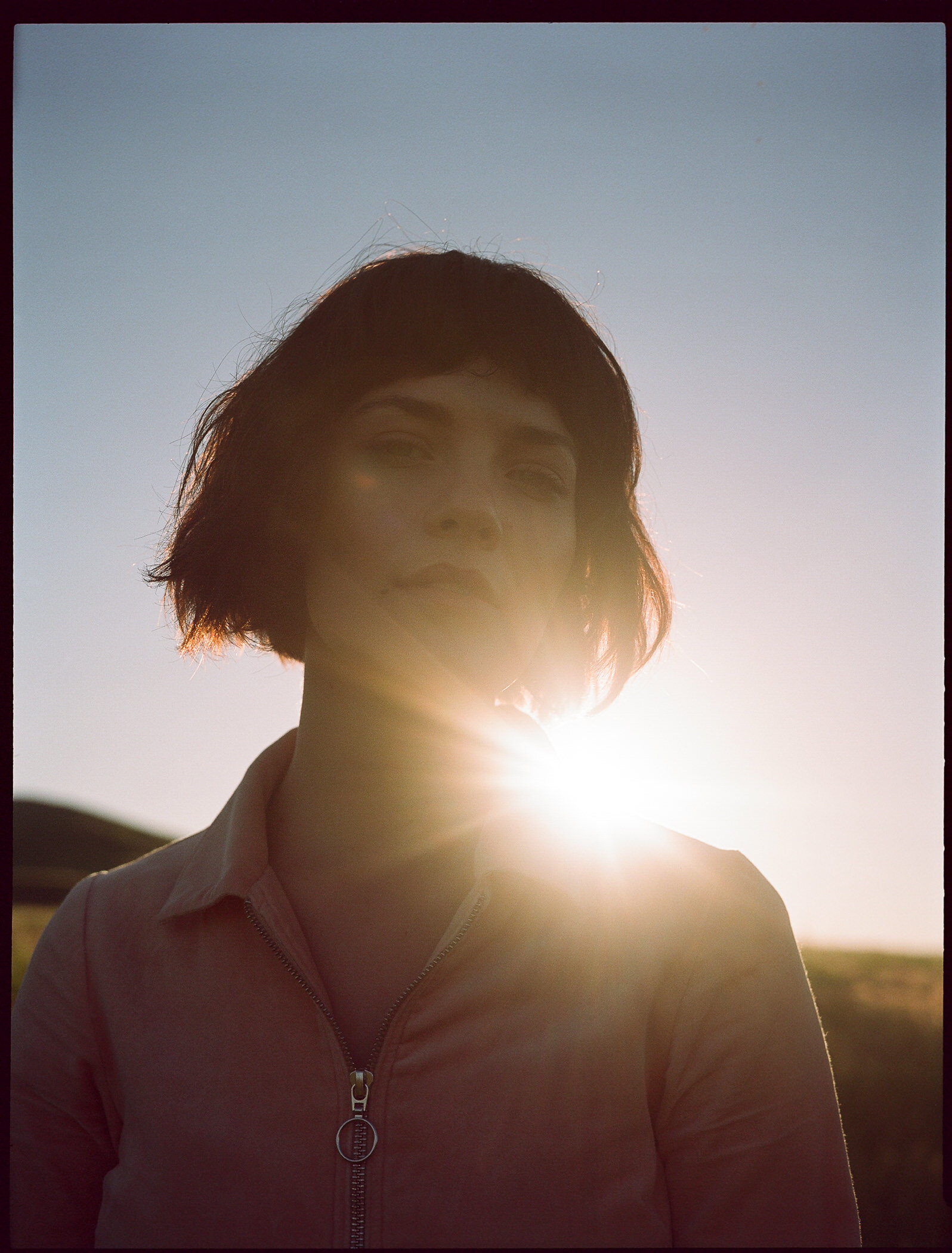 Medium format portrait of Hannah Fuchser; face is slightly distorted with the sunlight beaming at her shoulder