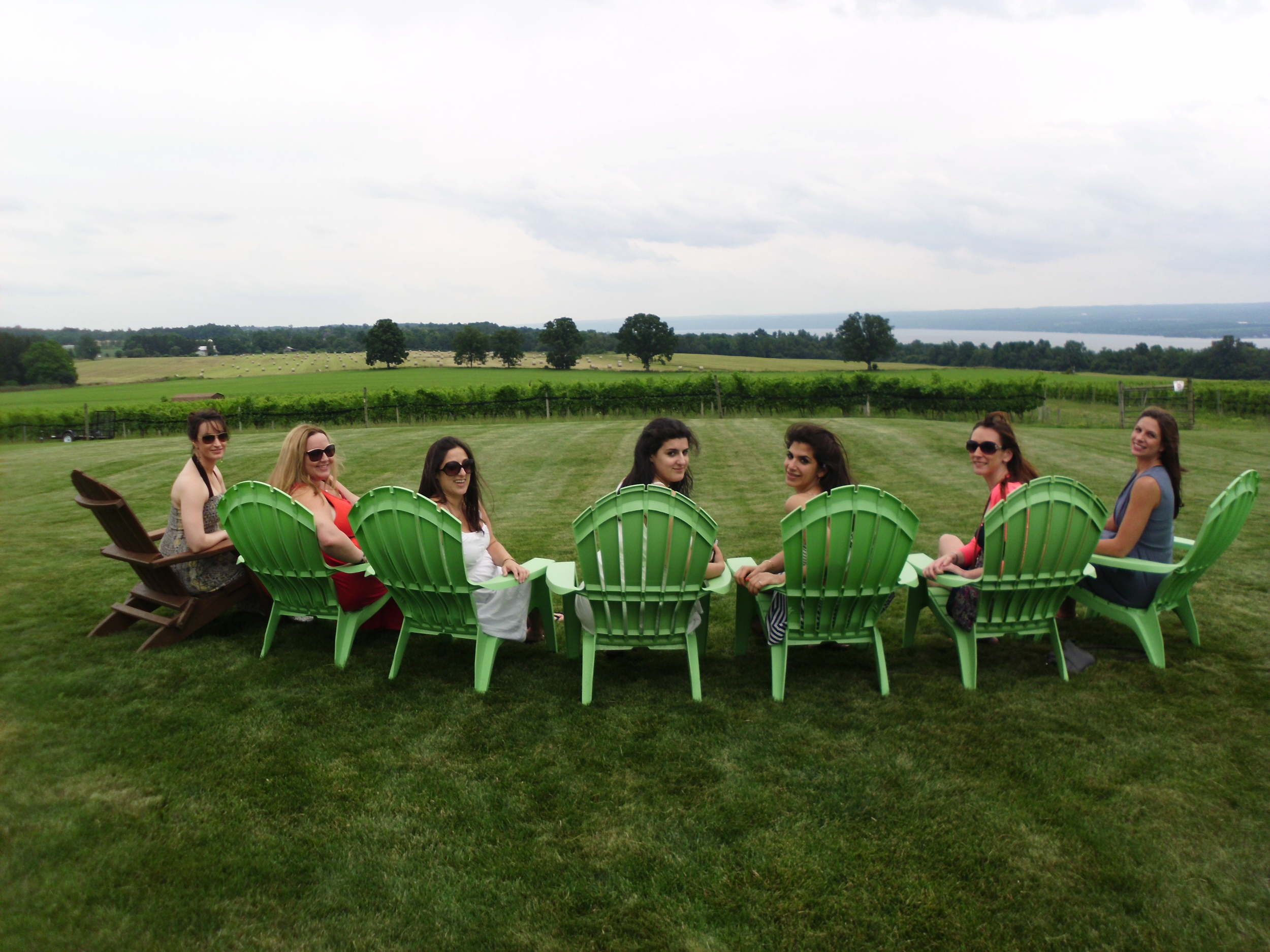 bachelorettes in green chairs with vineyard.JPG