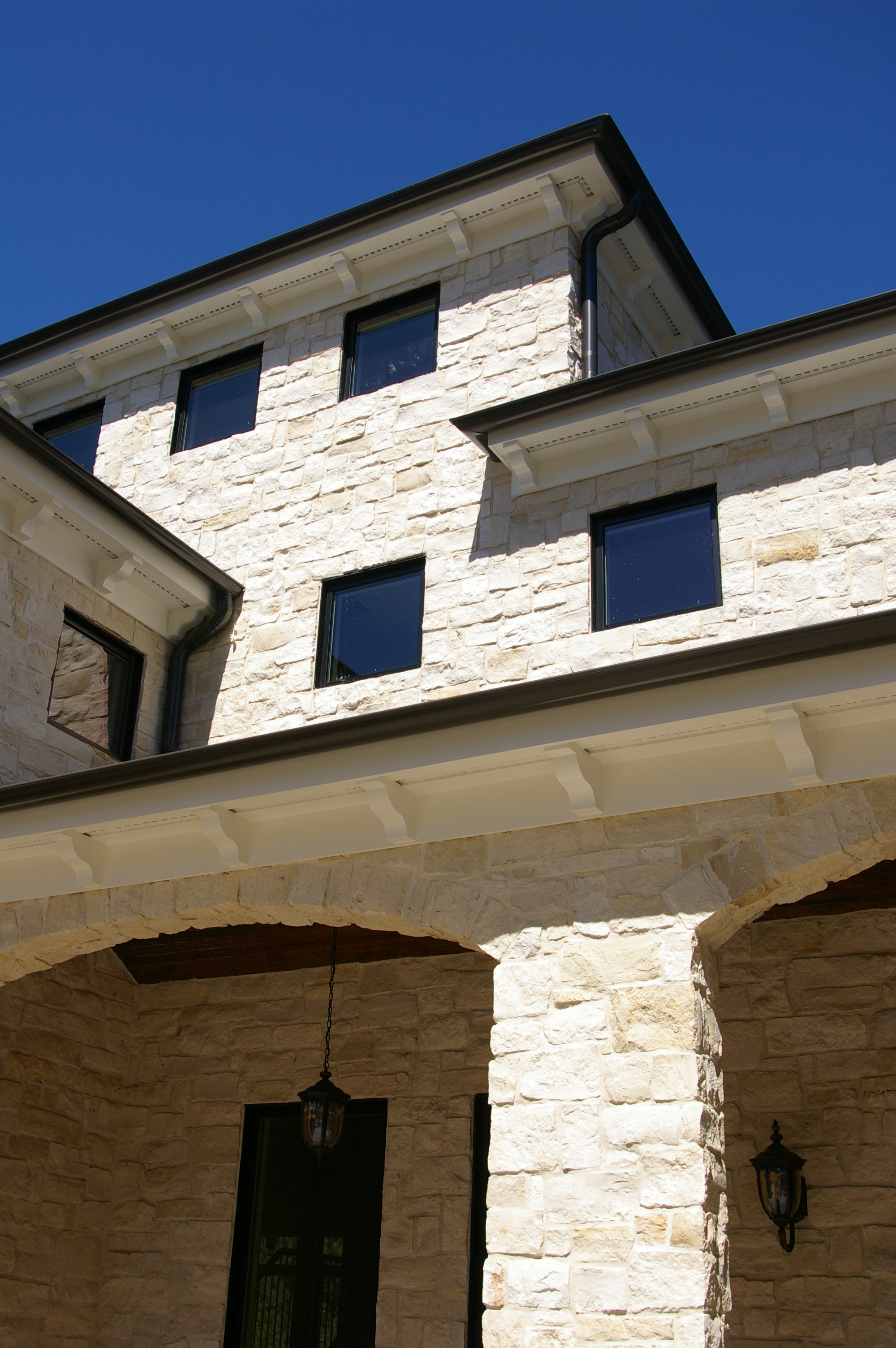  Exterior of home built using stone material from previous hometown. 