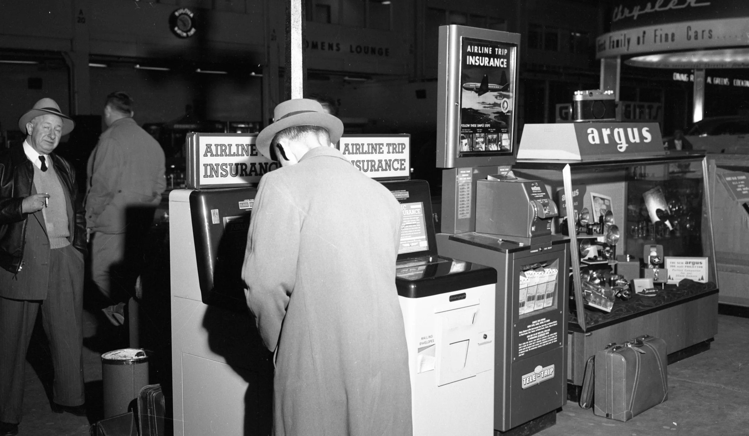 Travel Insurance Kiosks at Detroit’s Willow Run Airport, 1954. Part of the “Old News” collection at the Ann Arbor District Library. ( https://aadl.org/N186_0087_007 )
