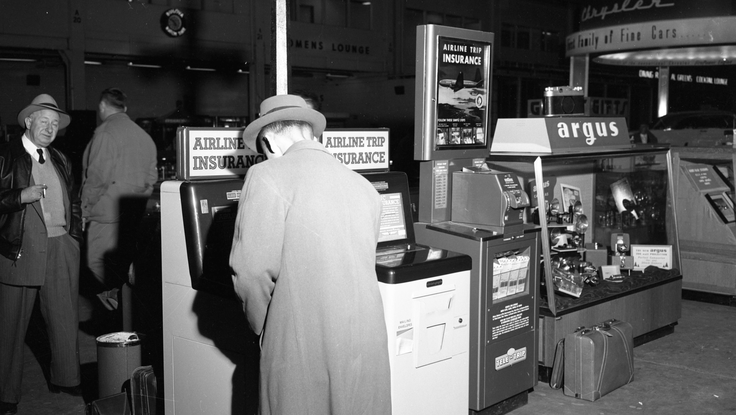 Travel Insurance Kiosks at Detroit’s Willow Run Airport, 1954. Part of the “Old News” collection at the Ann Arbor District Library. ( https://aadl.org/N186_0087_007 )