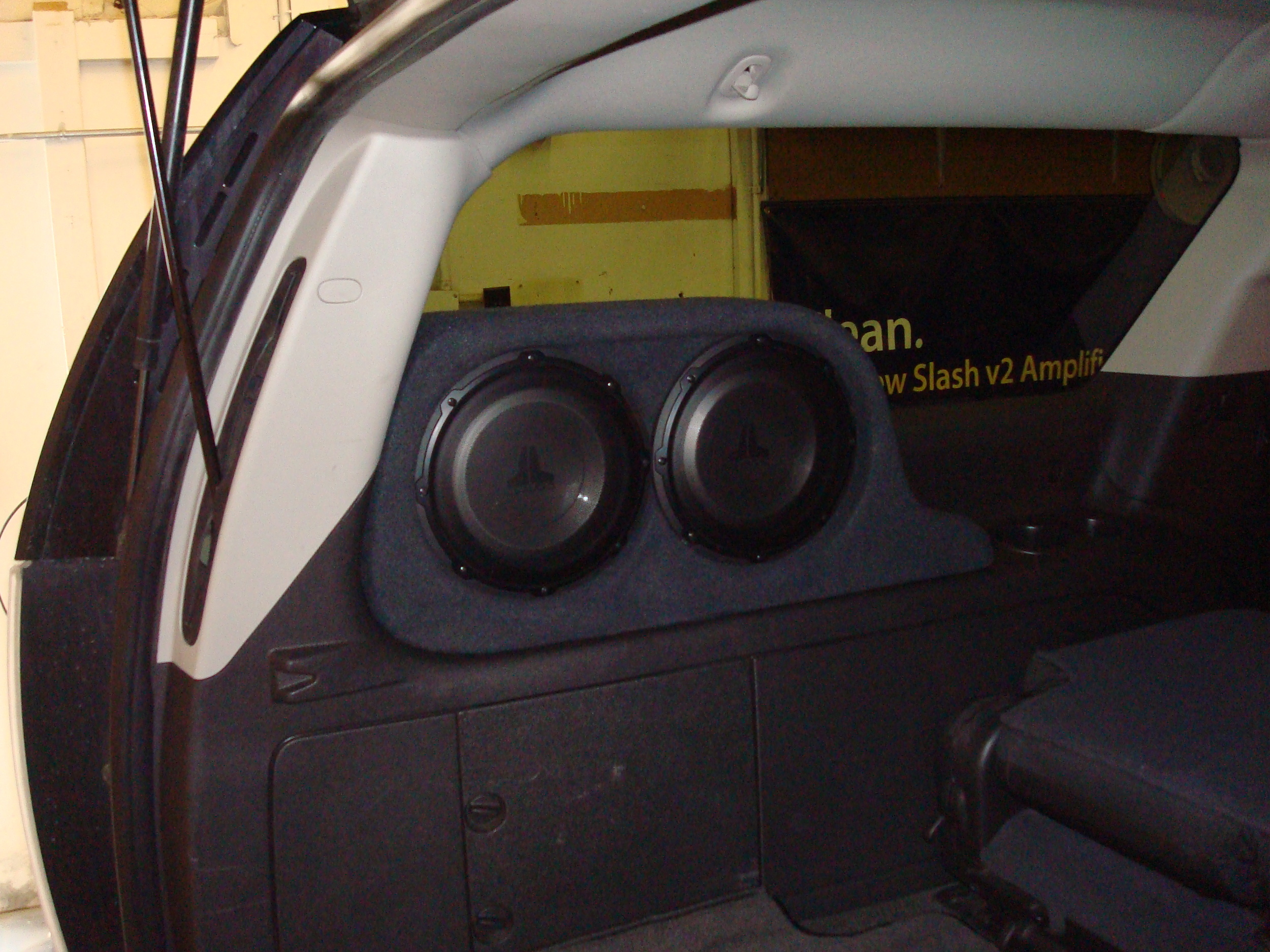 2007 Yukon Denali XL - JL Audio Stealthbox with (2) 10W1 subs.  Keeps the entire cargo area free.