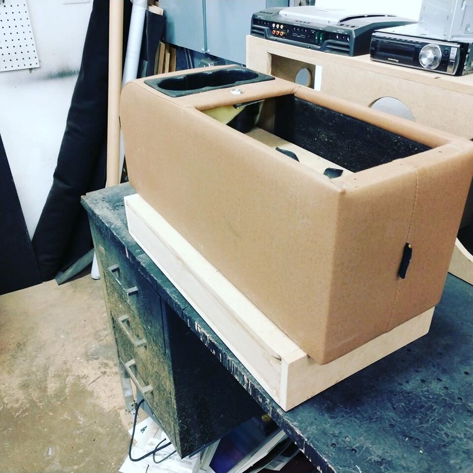 Custom enclosure in center console for subwoofer