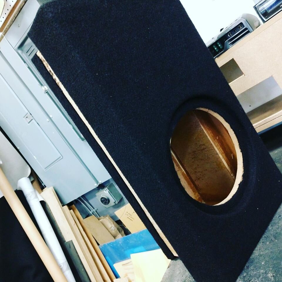 Custom enclosure in center console for subwoofer