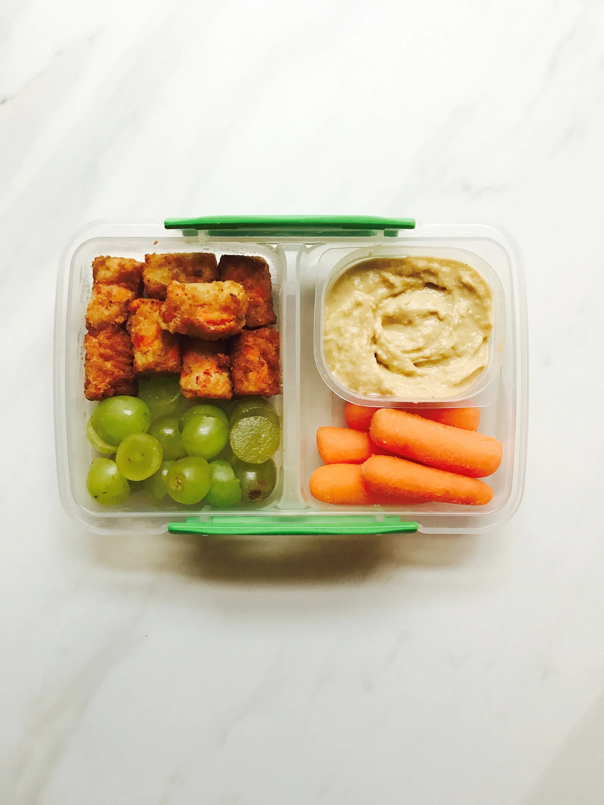 Dr. Praeger carrot puffs , green grapes, hummus, and baby carrots. 