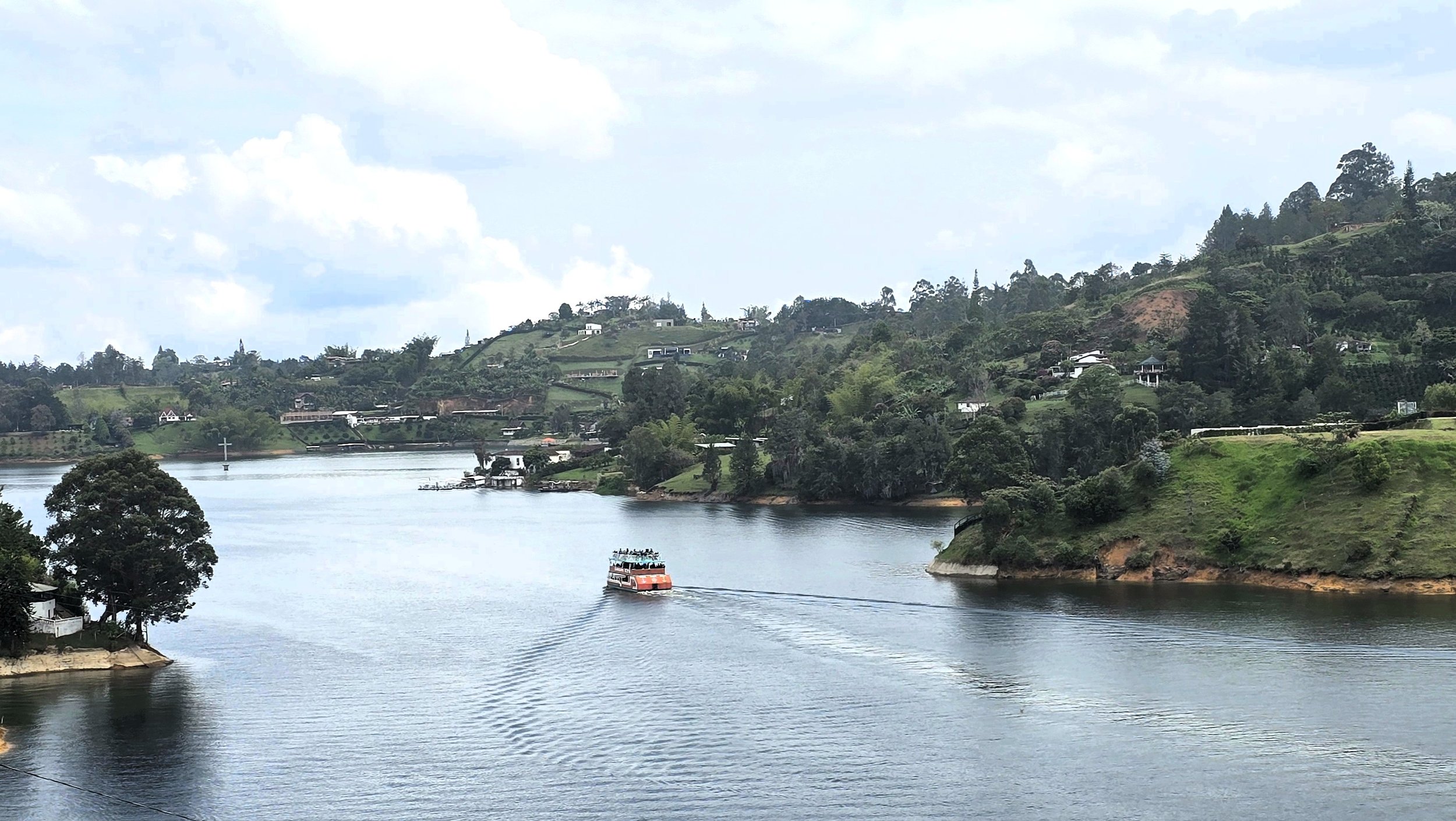 Boat on flooded town of Penol -- cross of former church.jpg