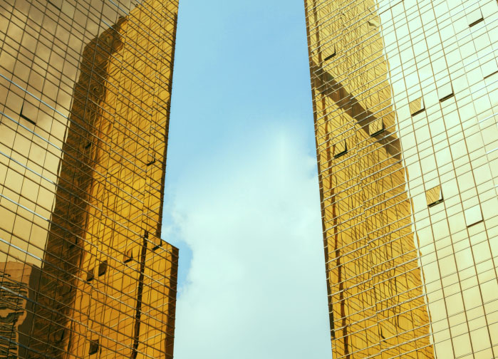 Small amounts of gold, frequently recycled from specialty metal recyclers like Gold Refiners, are being added to modern window glass to create energy saving, reflective surfaces. Credit: wonry/iStock.