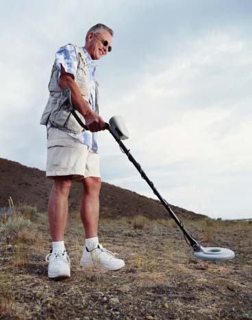 Shown: hobbyist with a metal detector searching for gold, silver and other precious metals which Specialty Metals can refine and recycle.