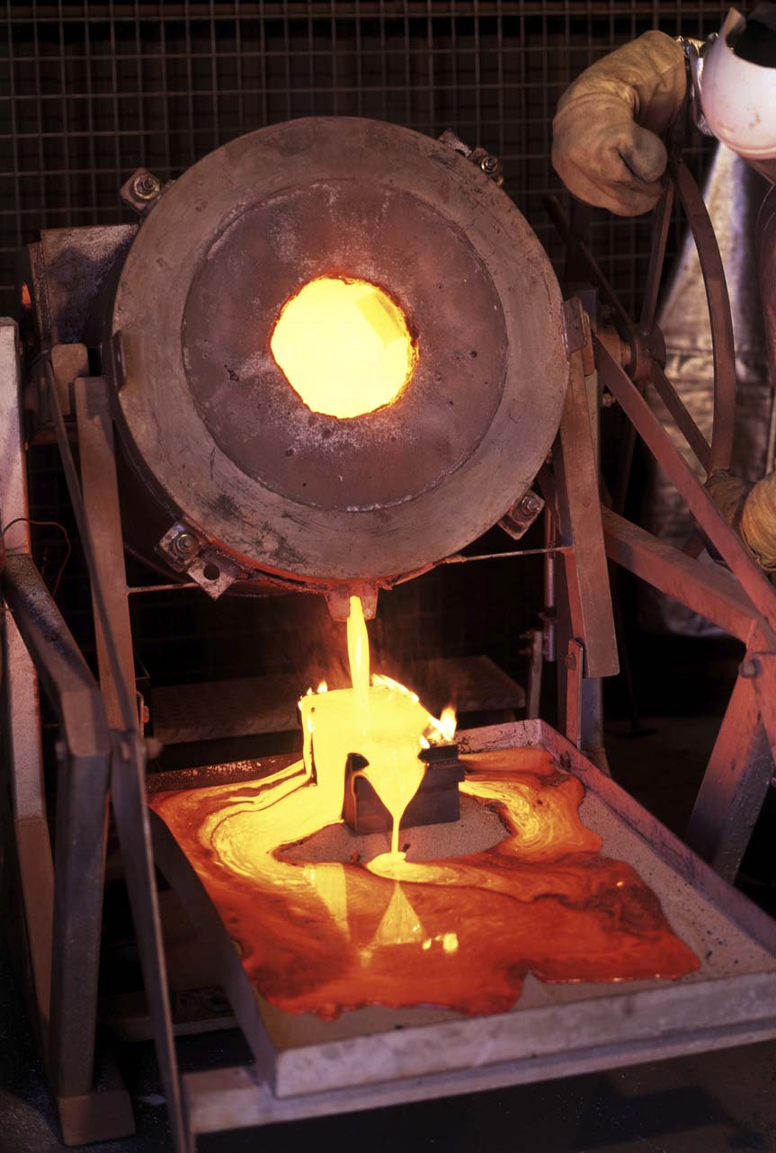 Photo of gold refiner pouring molten gold into a mold, used on GoldRefiners.com website. Credit: Slovegrove/iStock.