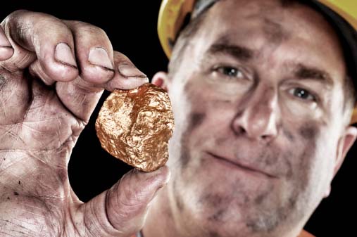 Photo of a miner with a gold nugget used for everything from jewelry to dental scrap to circuit boards, which can all be recycled by GoldRefiners.com, part of Specialty Metals Smelters & Refiners.