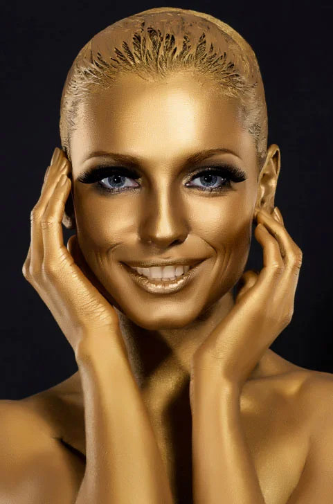 Shown: an image of a model covered in gold paint, to symbolize the question of how much gold is in the human body and other strange questions we get at GoldRefiners.com