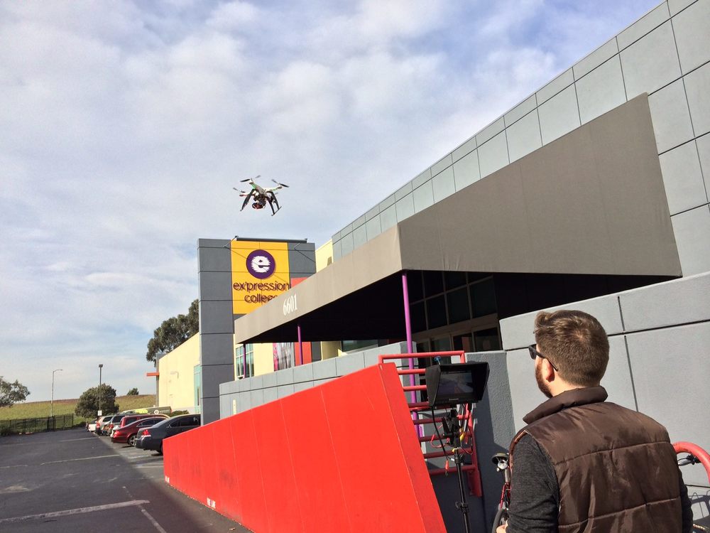 Piloting a quad copter with a GoPro Here 3 outside of Ex'pression College. Whatever it takes to get the shot.
