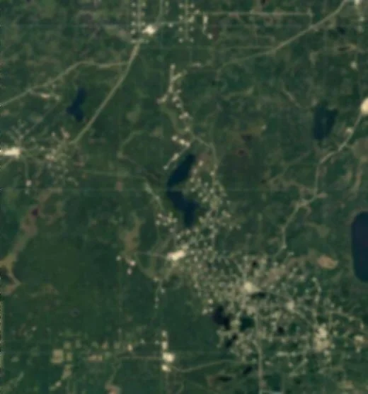 Blurred satellite view of customer's oilfield showing hundreds of well sites scattered over a large area