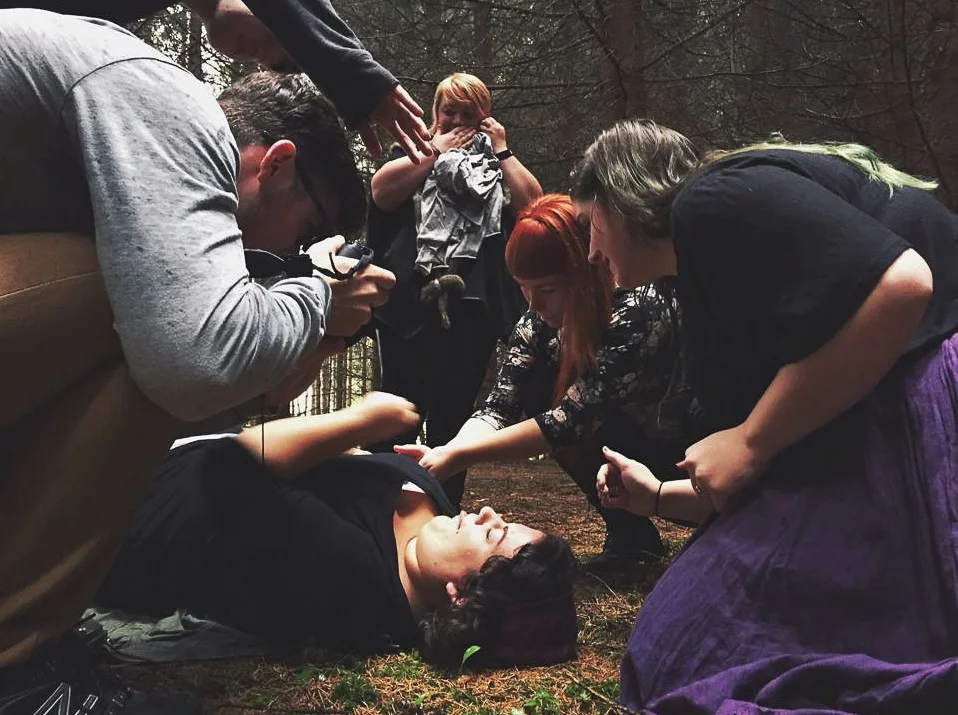 My trusty team of frog wranglers trying to re-capture Mr. Frog after he continually hopped off her face.