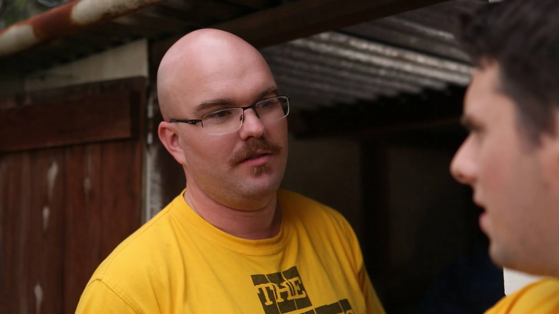 An outdoor, cleaning out the back shed moment with Gregg and Phillip (Craig Linderman)