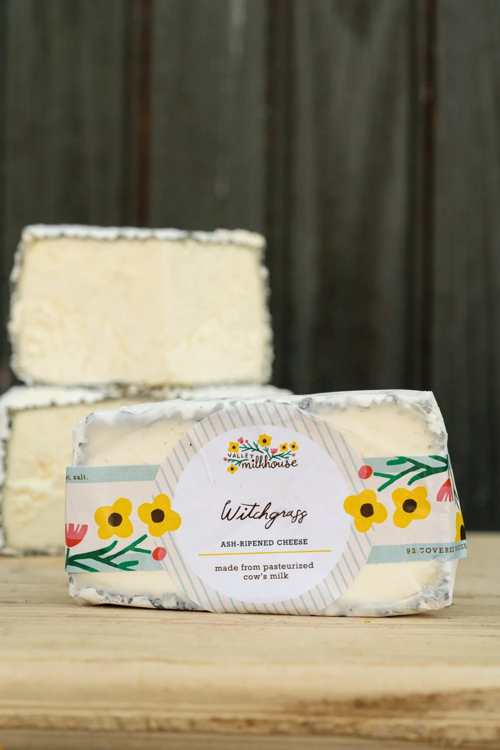Wheel of Witchgrass cheese wrapped in printed cheese paper with a handwritten label, from Valley Milkhouse CreameryZS_ValleyMilkhouse_114.jpg