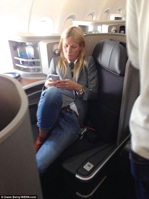 Gwyneth traveling 1st class and on her phone.