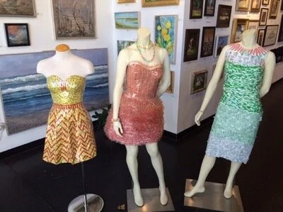 Past wearable art dresses created from Mary Jane Wrappers, Smartie Wrappers and Baby Wipe Packaging.