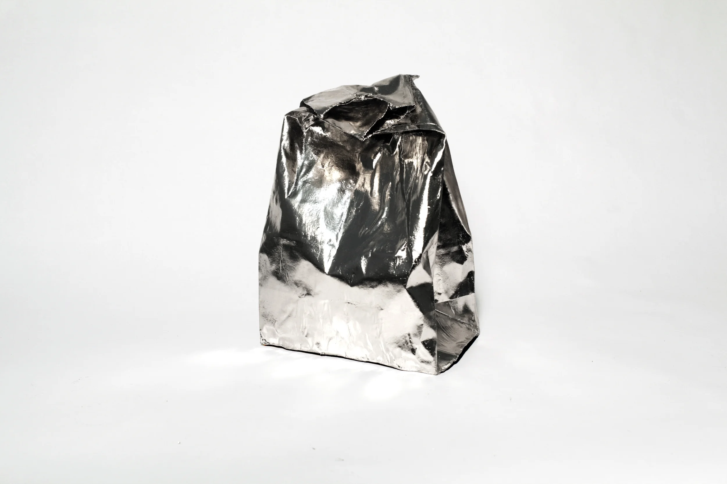 Liisa Lounila: The Best of Them All , 2012, palladium on brown paper bag, plaster and resin
