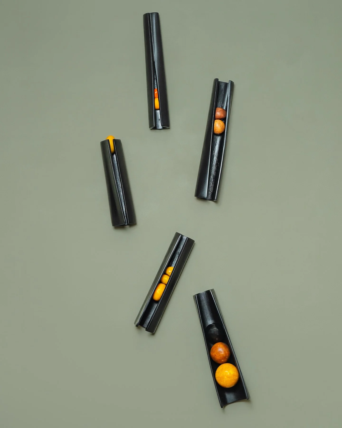 A Slanted View - HH 
Each segment of palm holds and encompasses the smooth earthly forms of calabash, amber, and seeds&mdash;symbols of growth, sustenance, and the cyclical nature of island life. The balance of motion and stillness reflects how natur