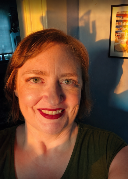 The author smiles at the camera.