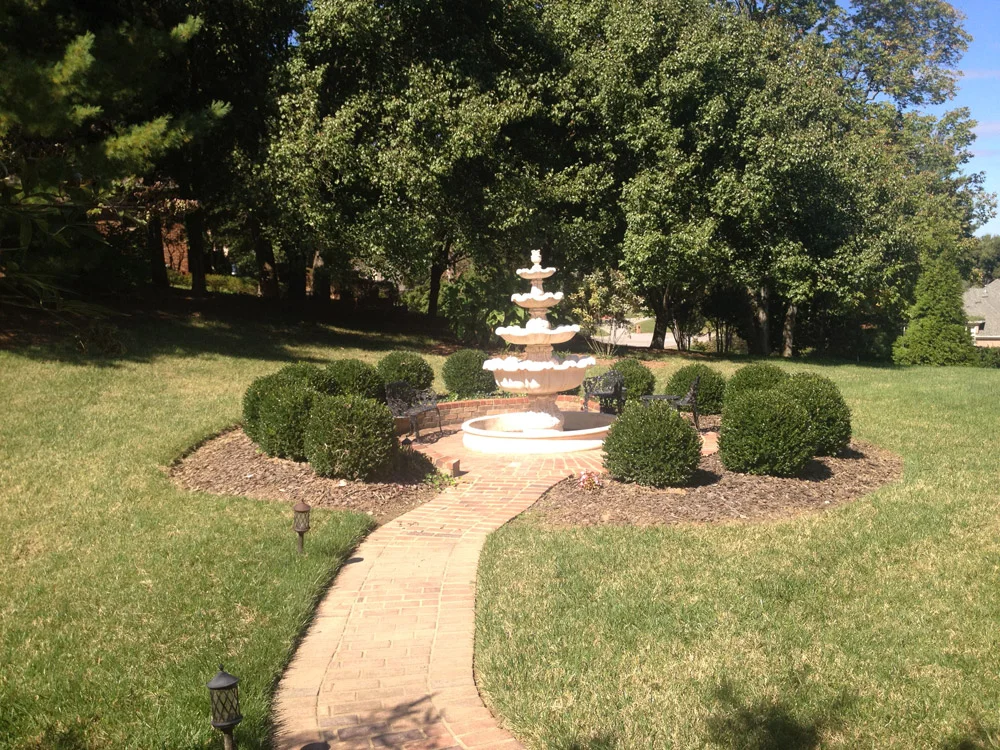 Brick pathway surrounding fountain