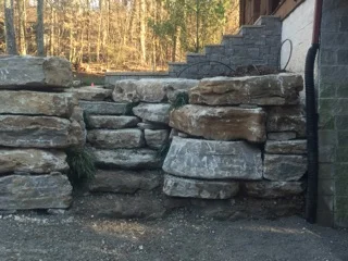 Natural stone used to construct retaining wall, stairwell and steps