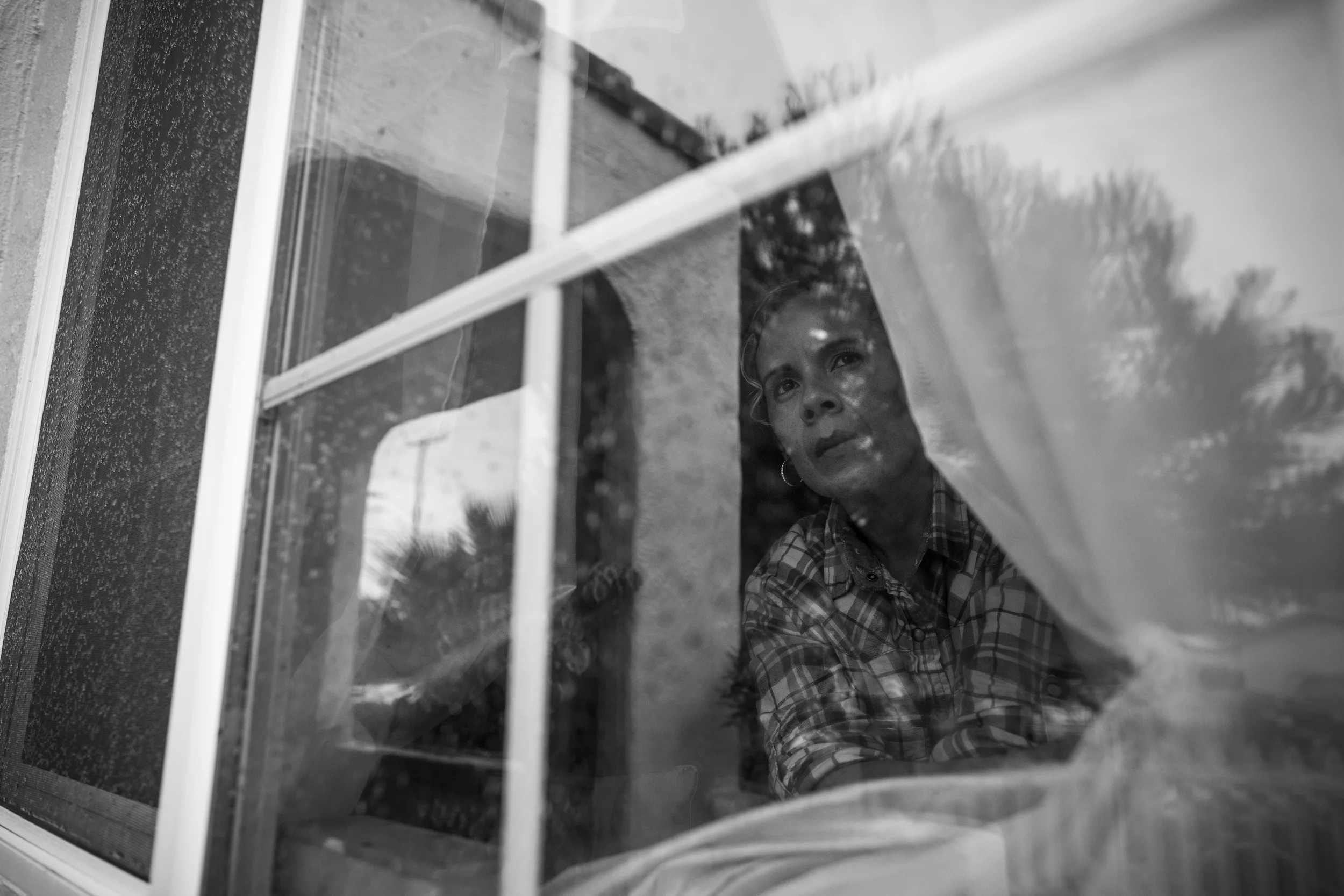 "People can make you feel like a slave," says Maria as she watches the cars drive down her street in Ventura, California.