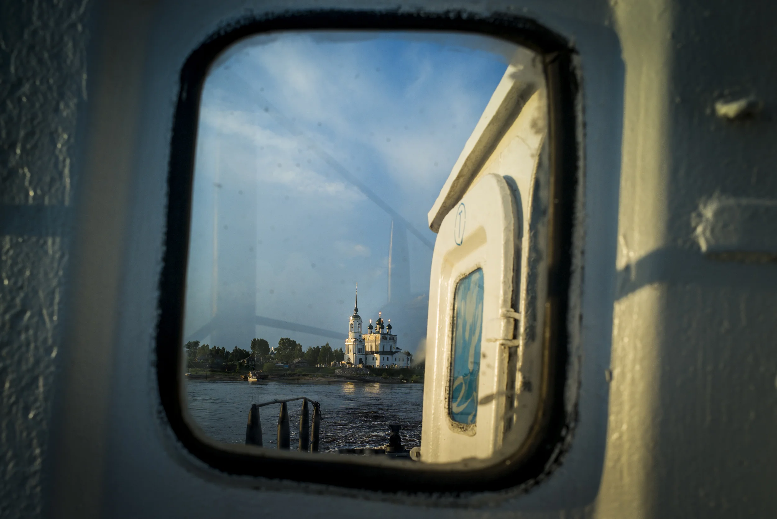 Through a clouded window, the Cathedral of the Annunciation can be seen from the Vychegda River in Russia on May 30, 2015. (© Alicia Afshar)