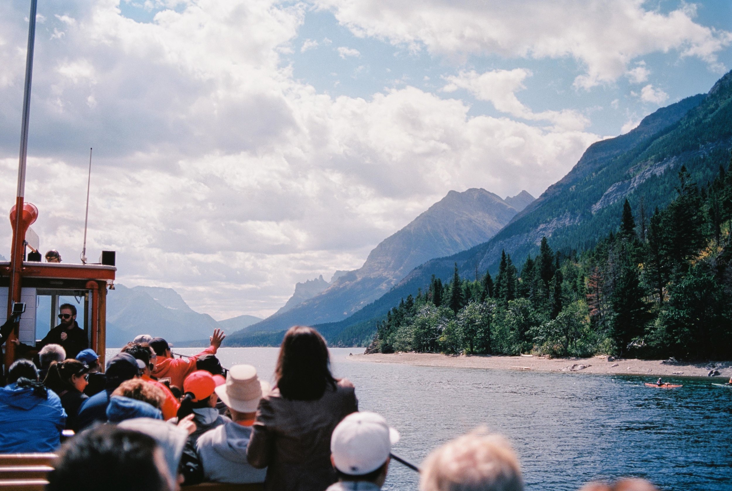 "Hospitality" Waterton Lakes National Park, AB, Canada (August 19, 2017) To me, this photograph sums up the friendly atmosphere of Waterton Lakes. I love how this visitor waved without hesitation to the kayakers near the shore during a cruise on The International. It was heartbreaking to see how devastating the wildfires were in this region last summer, and I look forward to seeing this wilderness gem bounce back after such great devastation. 