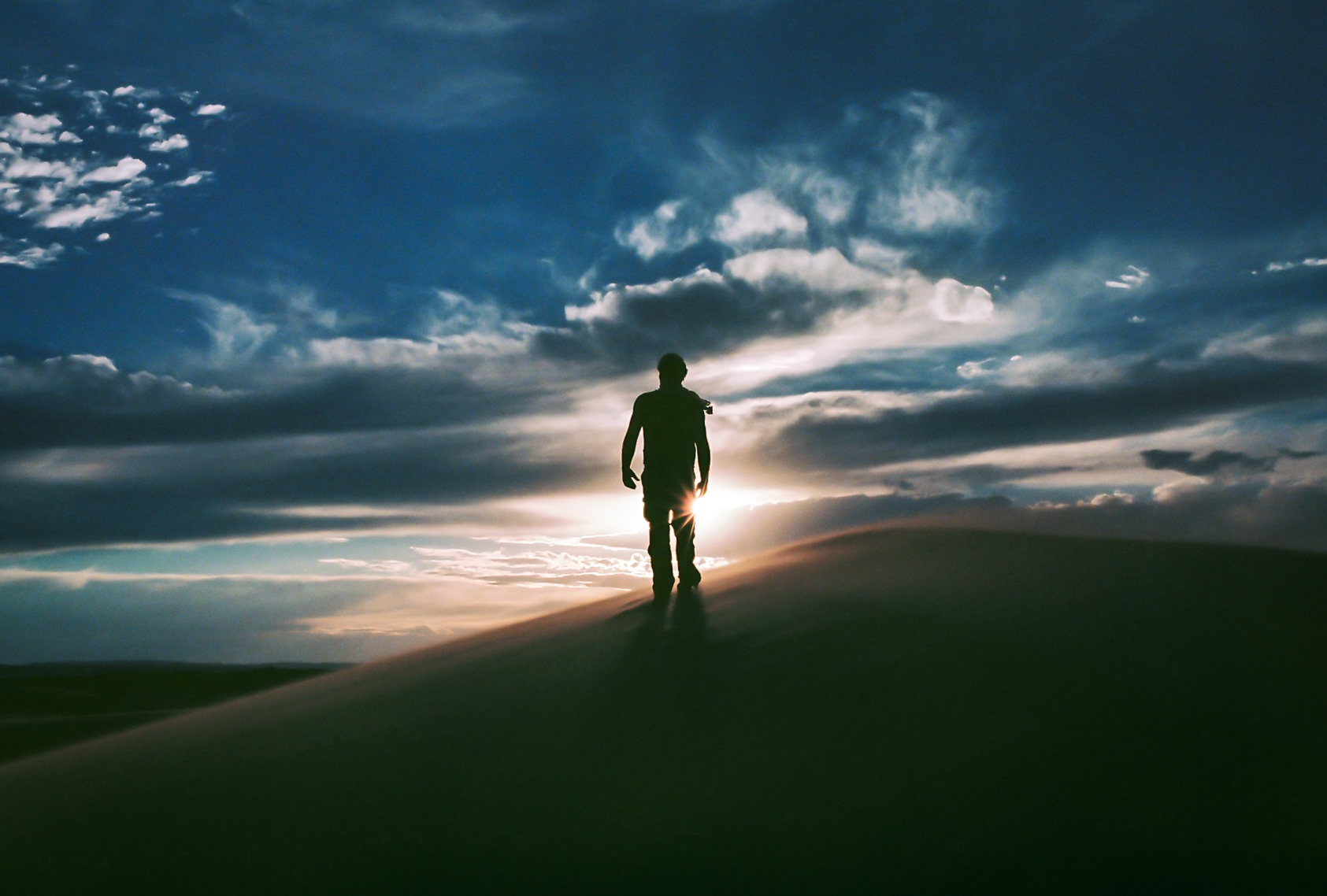 "On the Edge" Coral Pink Sand Dunes State Park, UT (May 24, 2017) Coral Pink Sand Dunes was one of the first places we stopped en route to Zion, part of a longer multi-day road trip during our move to Montana. We were racing the setting sun, hiking against fierce winds, and even had our cat on board with us. When I turned around and saw Ross with the sun perfectly flared behind him, I yelled "Don't move!!!" 