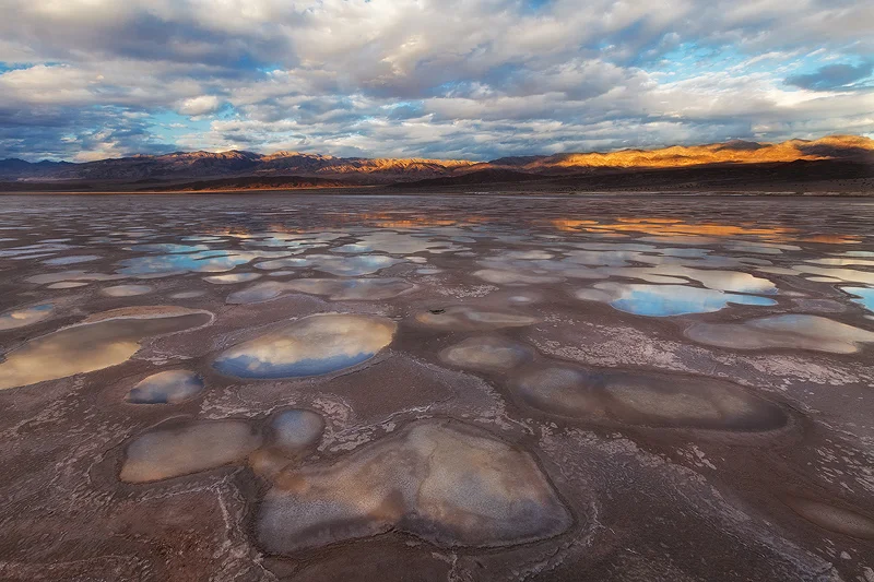 Small pools of water on a mud flat in Death Valley National Park