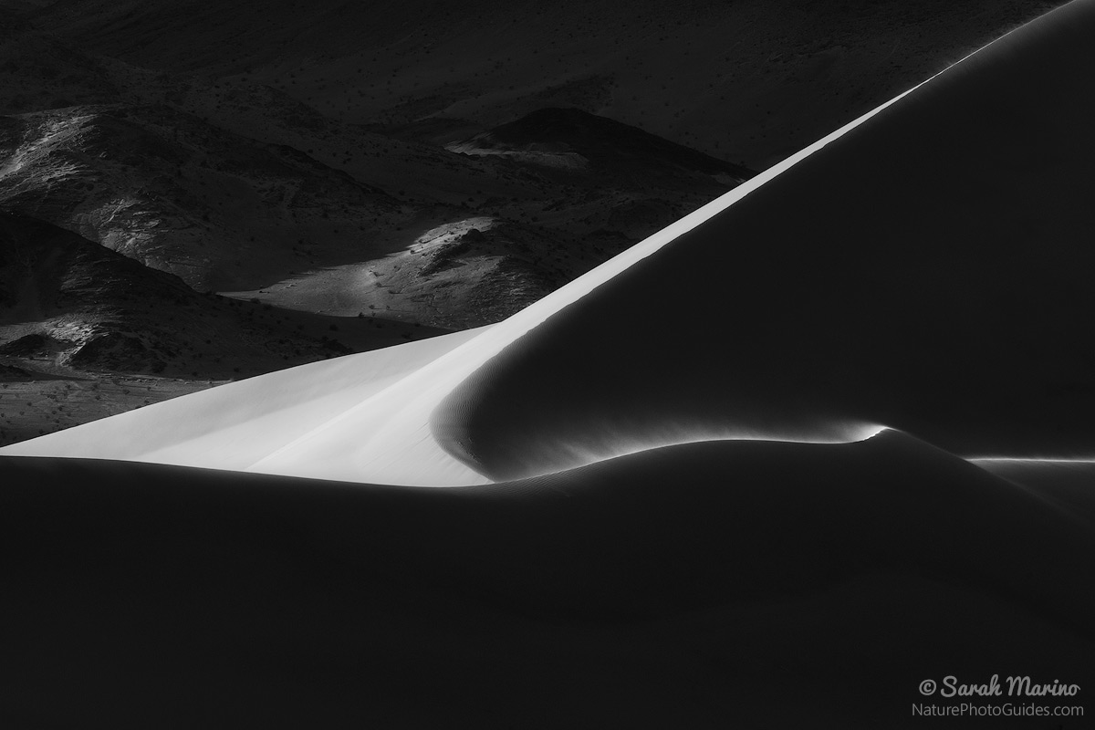 The last light of the day illuminates a ridge on remote sand dunes in Death Valley National Park. 