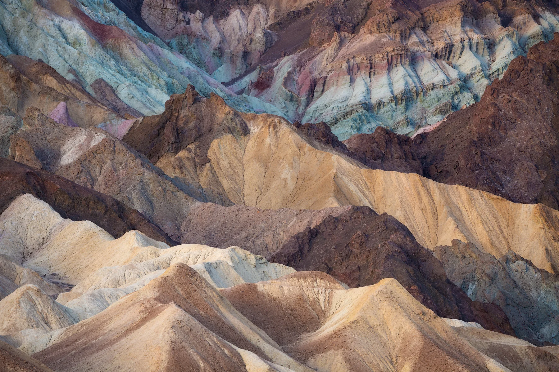 Colorful badlands, Death Valley National Park. For this spot, we saved the parking area in our car GPS and then specific vantage points that require hiking to access in our Gaia app. This makes navigating to the right spot at sunrise quite easy. 