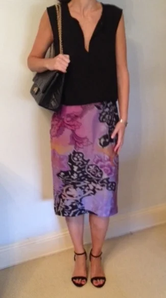 Silk blouse looks cleaner & dressier than casual sweater. Bag is also dressier. Although these shoes also have ankle straps, they are more delicate and don't cut the leg. Overall look, cleaner & classier.
