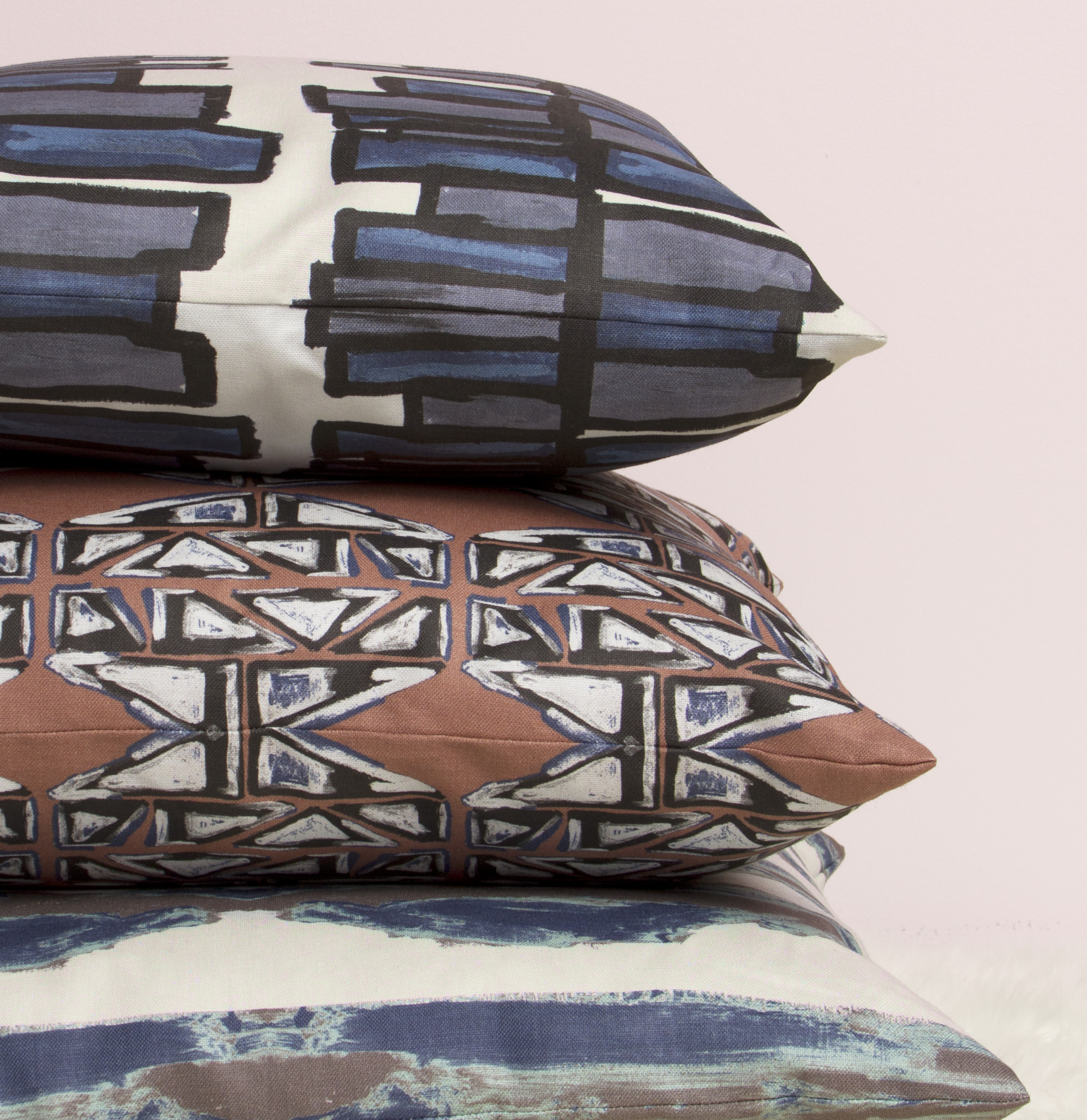 stack of pillows - against pink wall.jpg