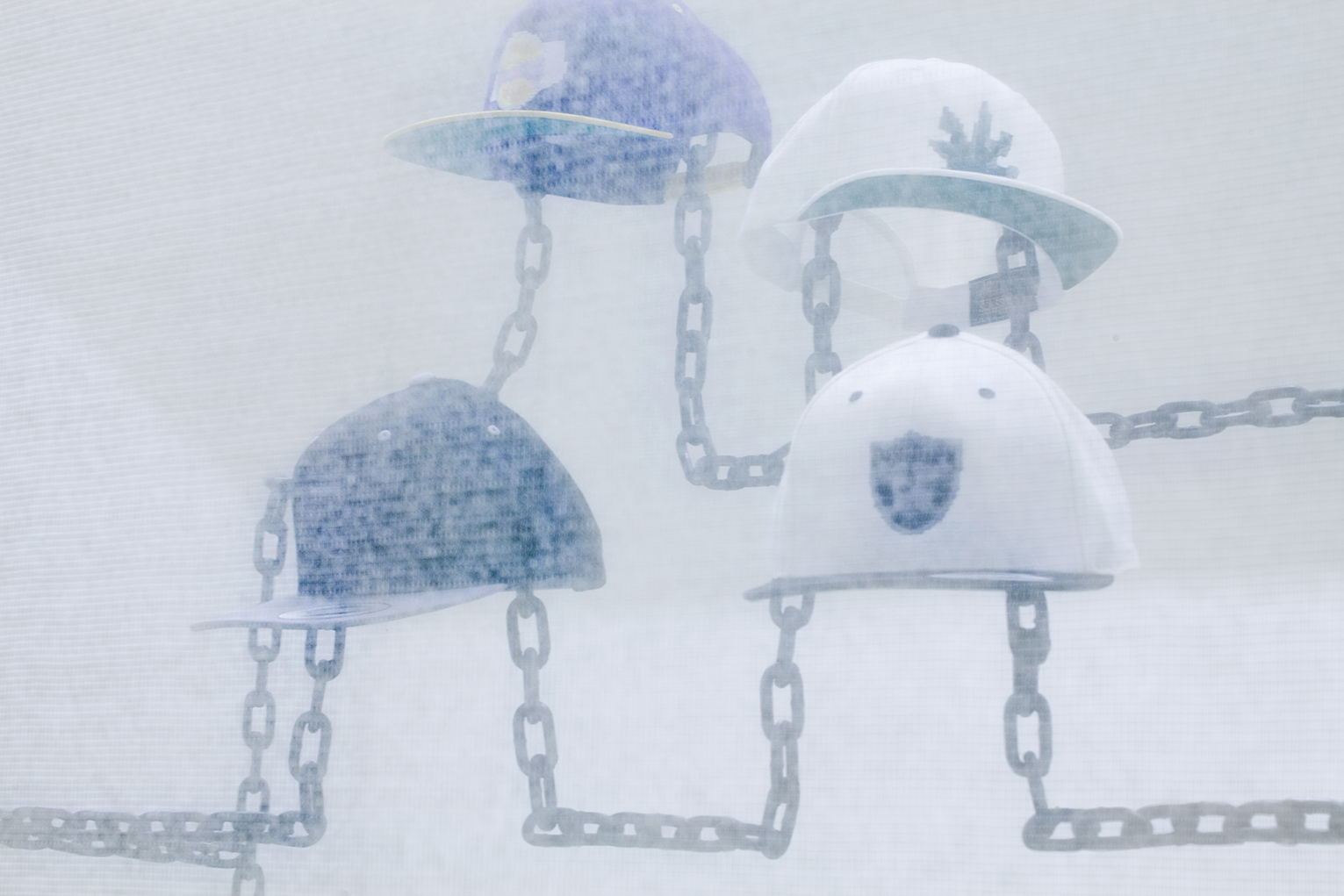  Robin Jiro Margerin  Express yourself (Chain gang)  2014 Six digitally blurred logos embroidered on classic snap-back caps, welded steel chain, color inkjet print Courtesy of the artist 