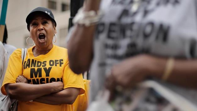 etiree Evelyn Smith, left, protests near the federal courthouse in Detroit, Mich., on July 3, 2014