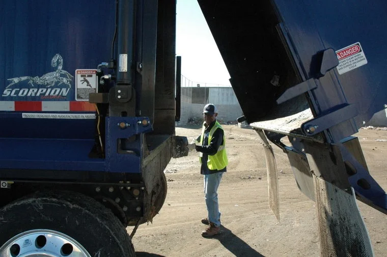 Photo by Leslie McMorrow As part of their safety checks, Peoria sanitation drivers are tasked with cleaning the seals of their trucks after each dump, to help reduce possible leaks.
