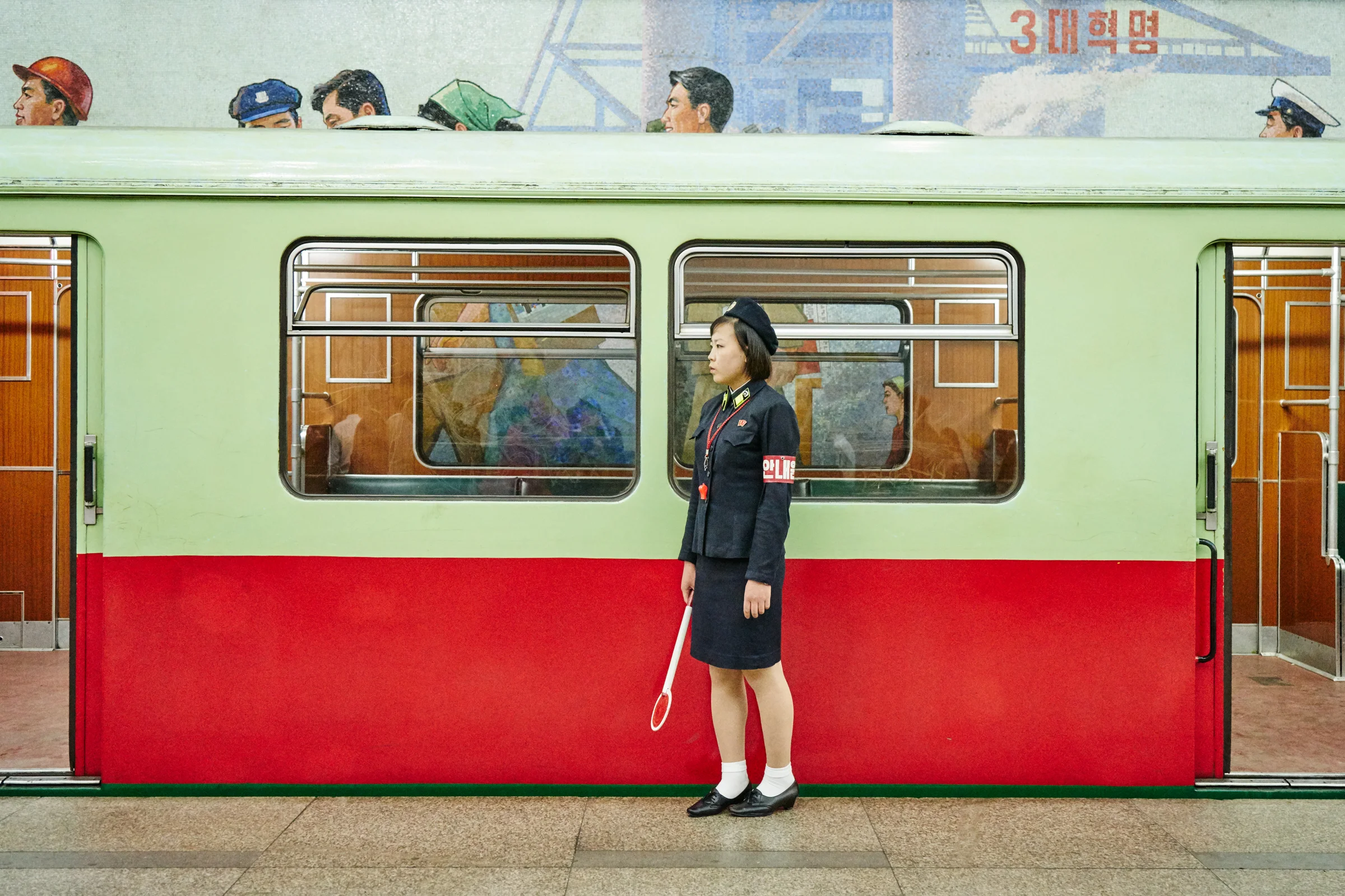 Train conductor, Pyongyang metro station. 