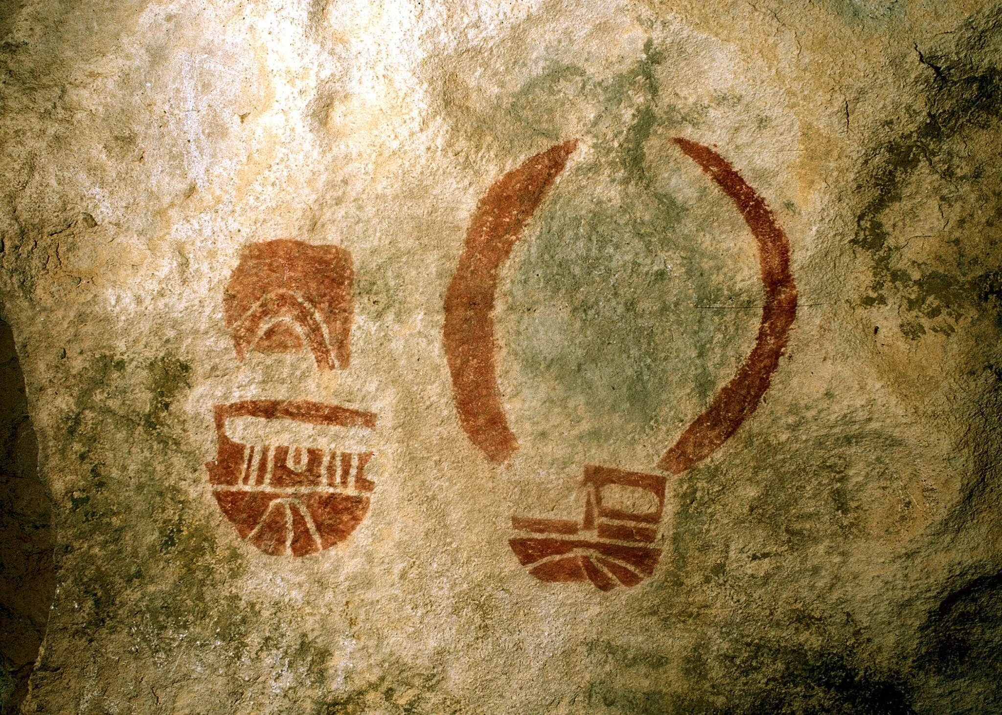 These red mask rock art images are located in the Cave Kiva site at Hueco Tanks State Park and Historic Site. Hueco Tanks contains over 200 face-like and mask pictographs, the most painted images of this type of any single location in the Americas.